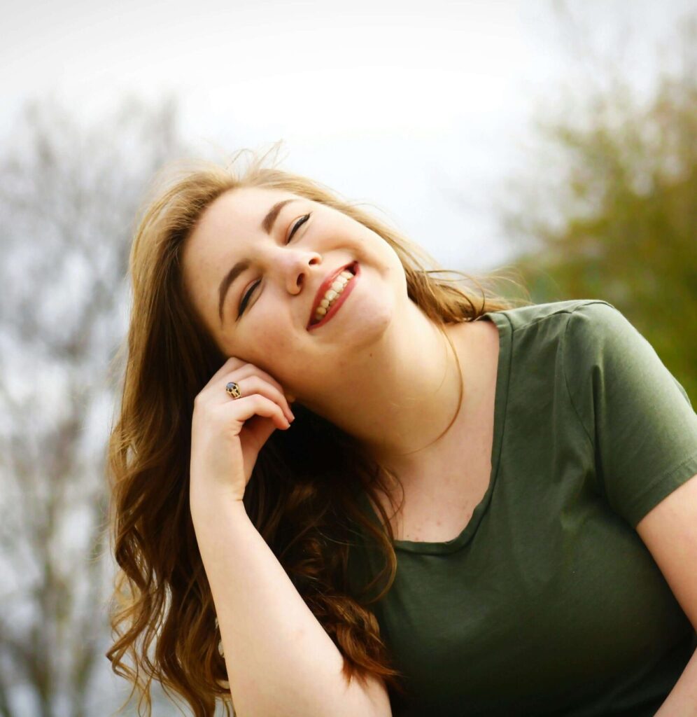 Woman smiling outdoors, finding lightness in her journey through depression