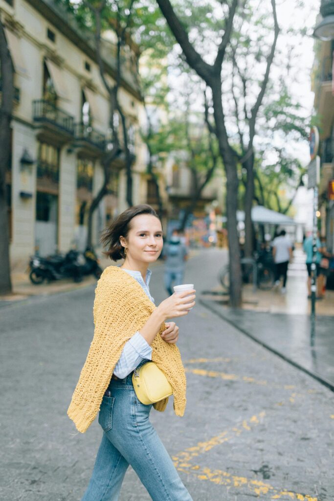 Woman walking outdoors with coffee, taking a small step toward healing from depression