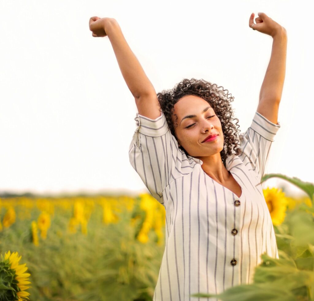 Woman stretching outdoors, reconnecting with her body during depression recovery
